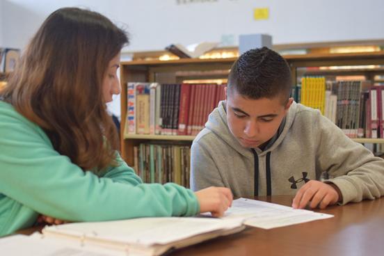Teacher working with young Hispanic student
