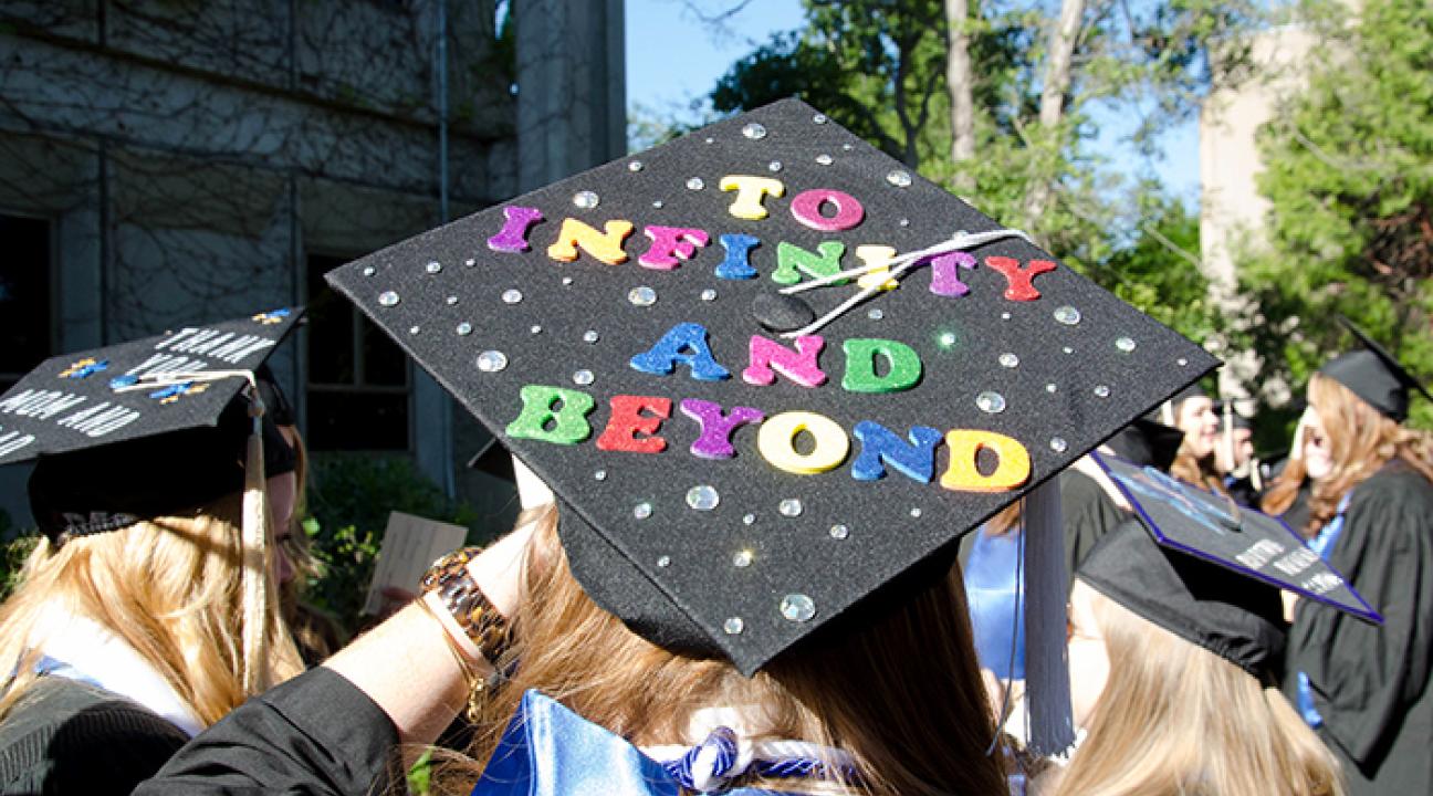 Grad cap reading "To infinity and beyond"