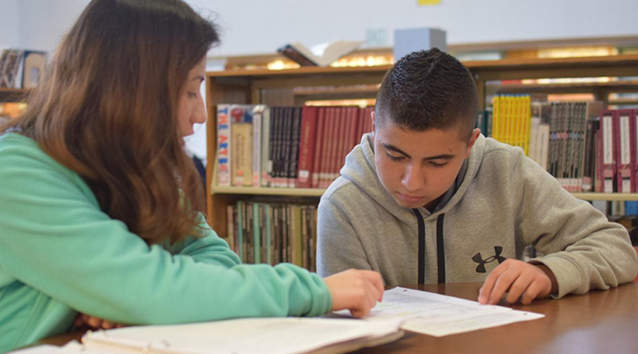 MEAP advisor Angelica Arguelles ​works with Rancho Cotate High School student Luis Maldonado on picking a subject for a speech and debate class.